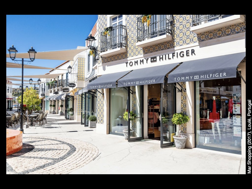 A picture containing text, outdoor, shop
Description automatically generated